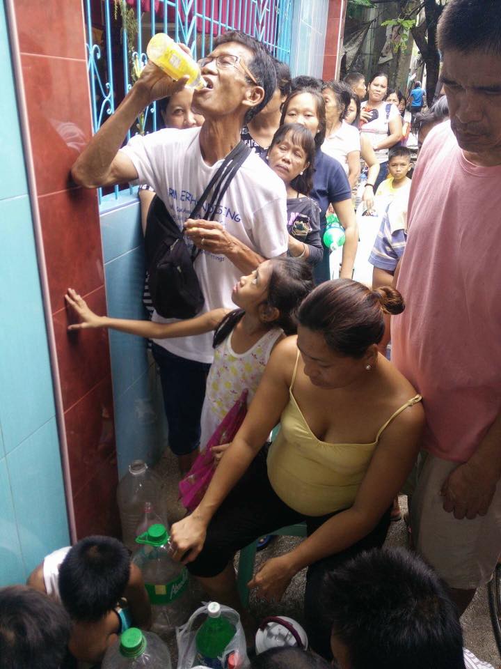CAUTION. Residents lineup to drink water that began dripping from a crack in the San Roque Parish in Basak-Pardo. (Photo from DYLA Facebook page)