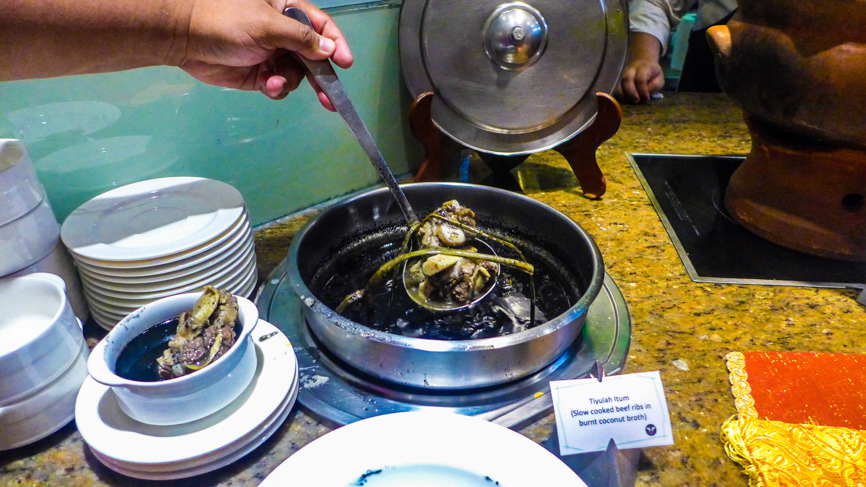 TIYULAH ITUM is a Tausug dish of slow-cooked beef in burnt coconut broth.