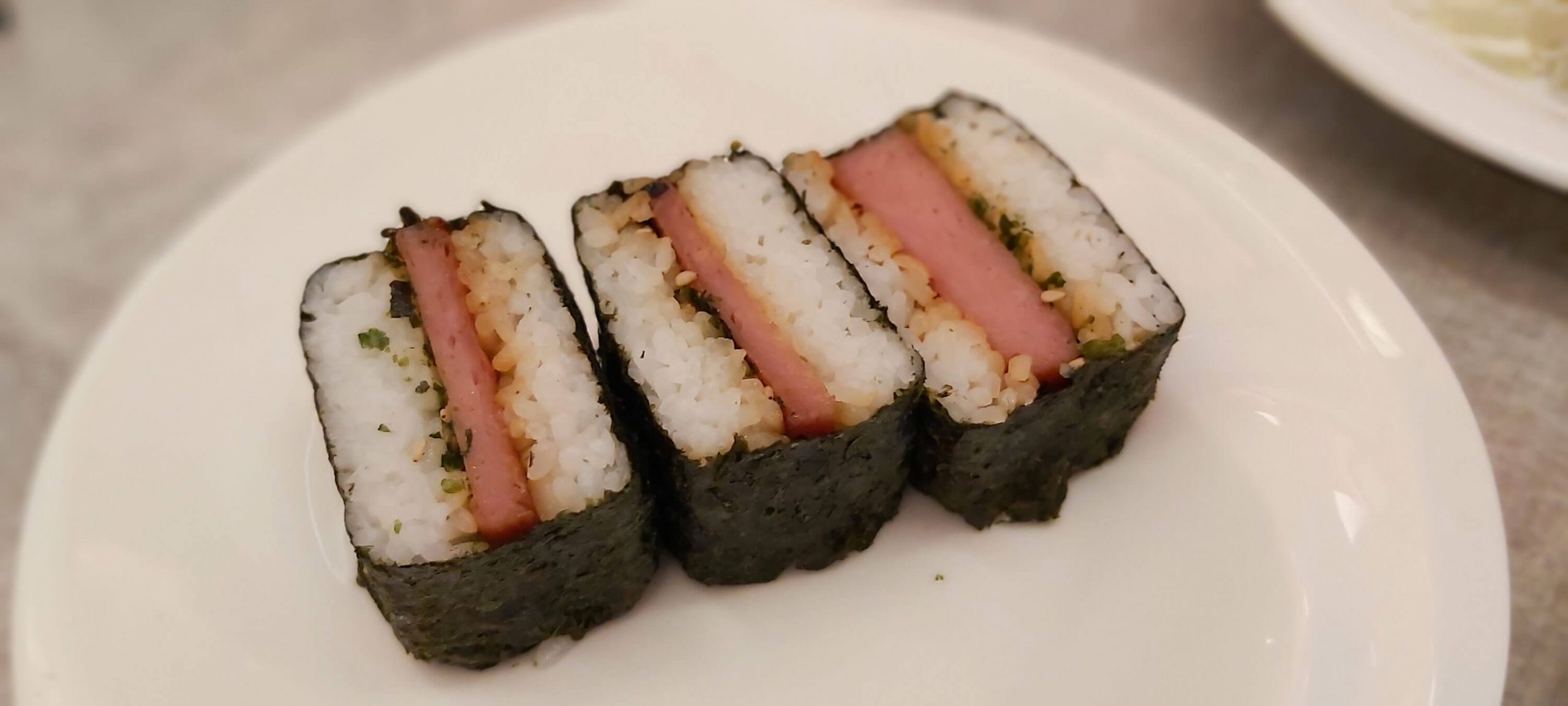 SPAM MUSUBI. This is a popular snack in Hawaii. The dish is made of spam on top of a block of rice and wrapped with nori.
