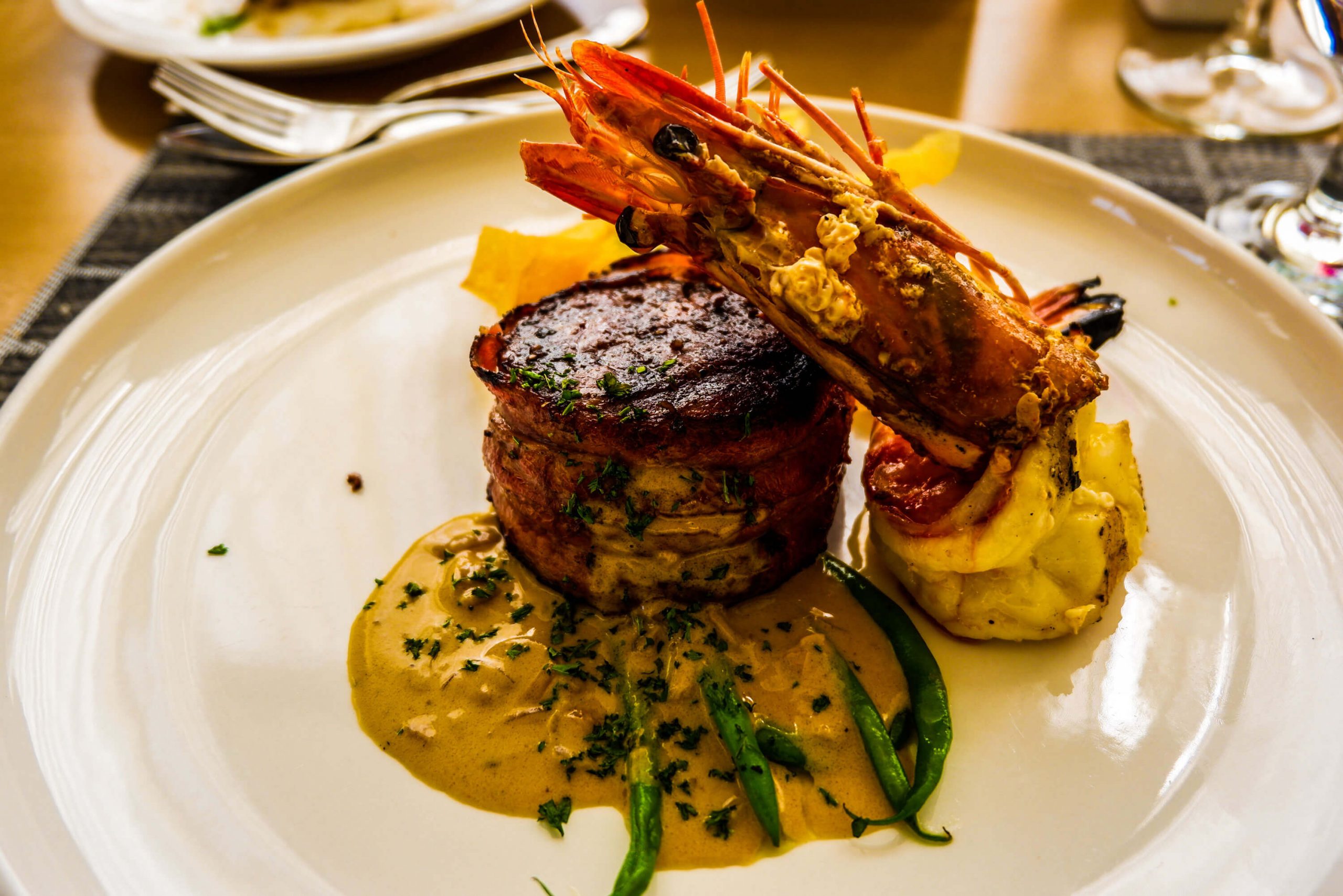 YIN & YANG. Fillet mignon with grilled prawn and crispy layered potatoes. The dish is of wagyu fillet mignon and prawn grilled and seasoned to perfection, served with mushroom sauce.