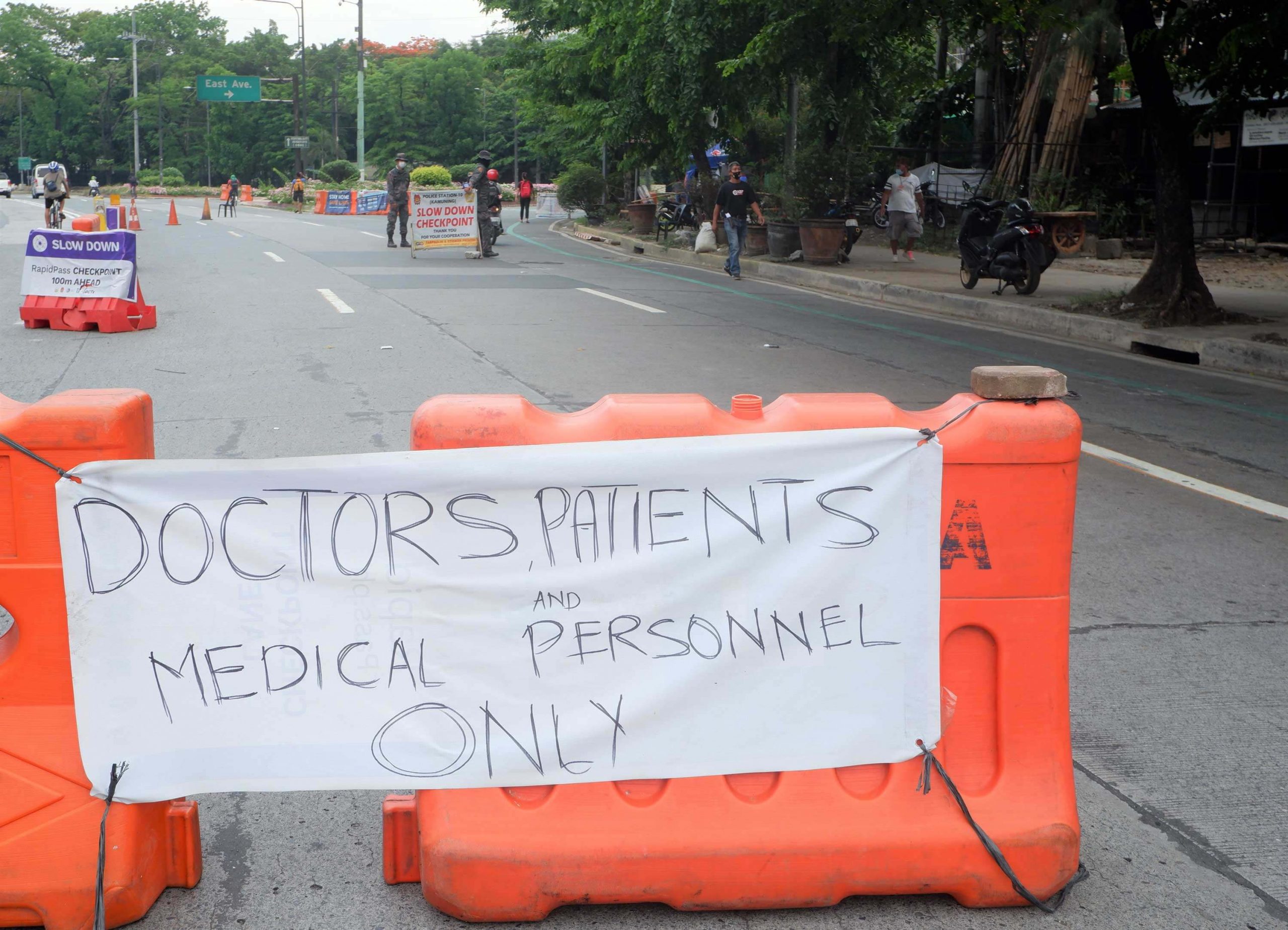 FRONTLINERS ONLY. Authorities monitor those entering East Avenue from the Elliptical Road to BIR road in Quezon City, where there are several major hospitals. Only doctors, medical personnel, and patients are given the priority to access the area. (PNA photo by Robert Oswald P. Alfiler)