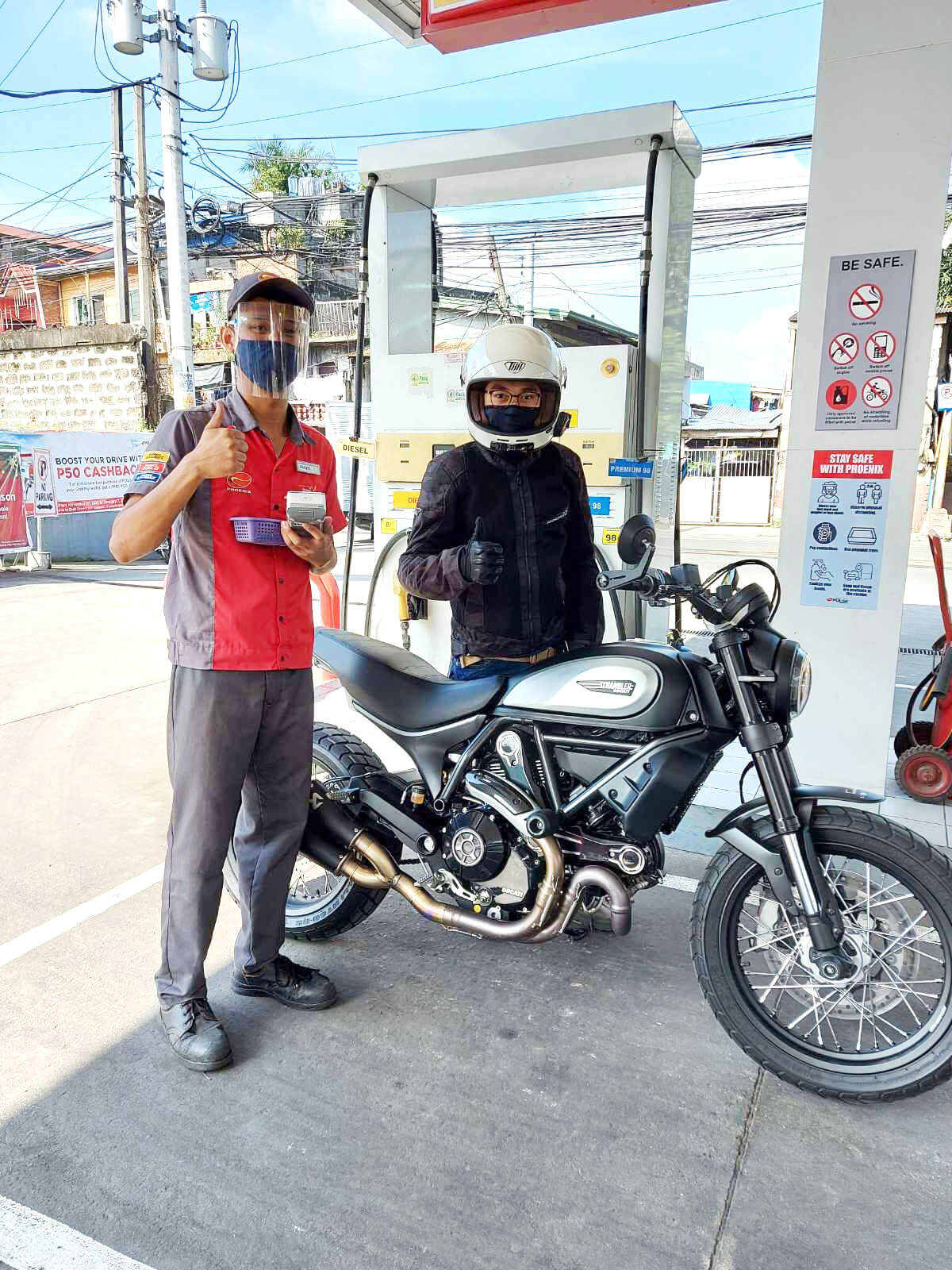 A motorist redeems his discounted fuel voucher at a Phoenix gas station through the Limitless app