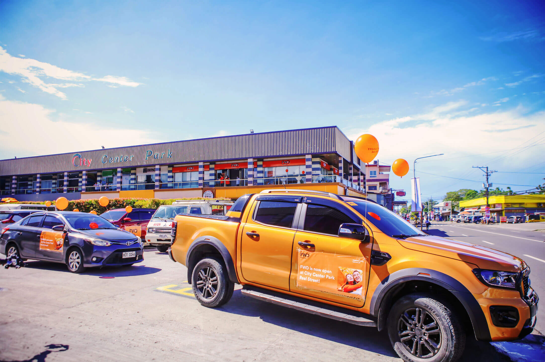 A motorcade converges right in front of the Tacloban City Center Park where the new FWD business hub is located.