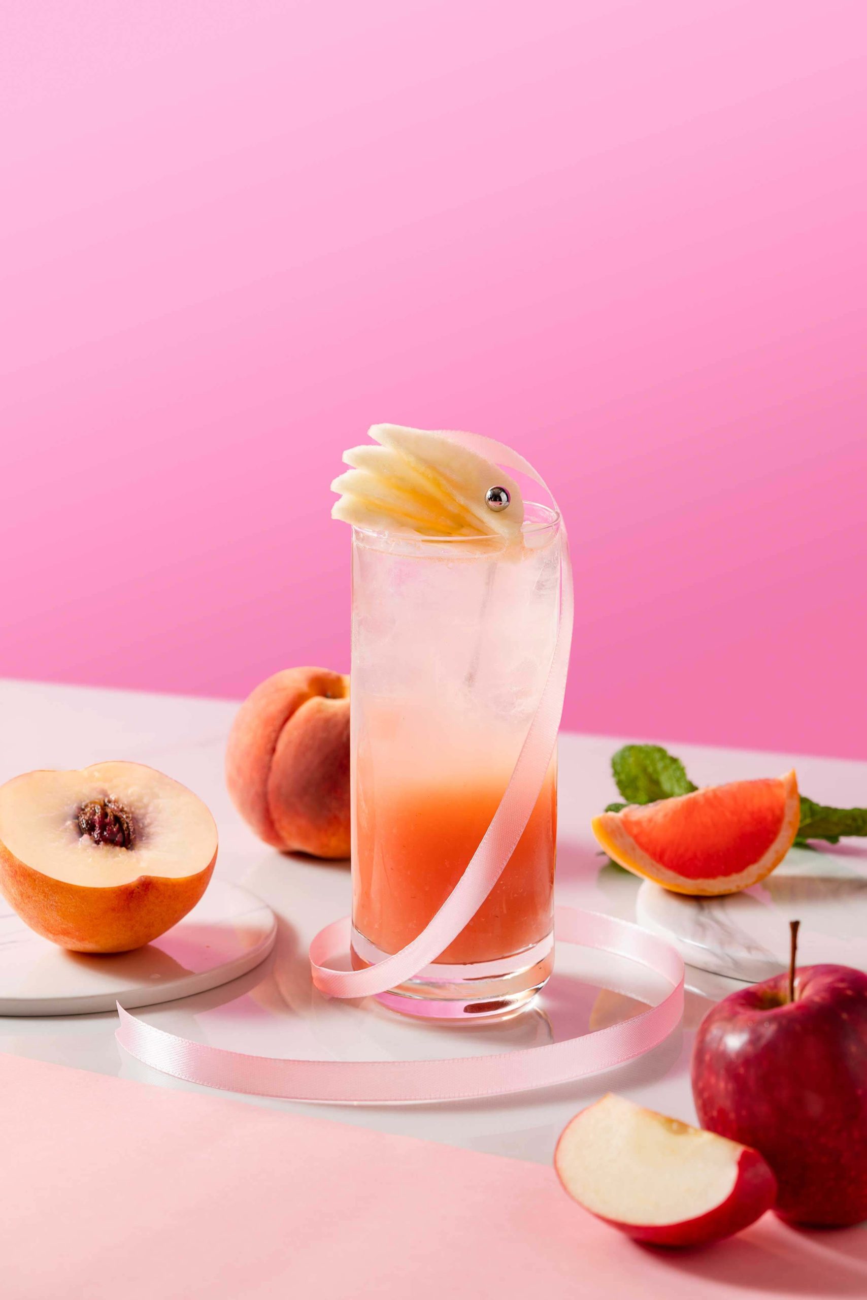 The Pink Highball mocktail is a cold brewed oolong tea infused with apple juice and peach puree. Finished with a splash of grapefruit juice, the fruity and refreshing concoction is both sweet and tangy.
